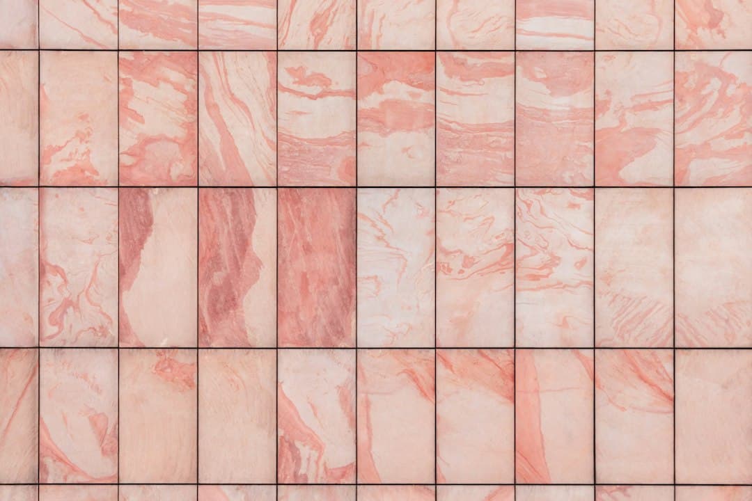 a close up of a pink marble tile wall — Photo by Pawel Czerwinski on Unsplash