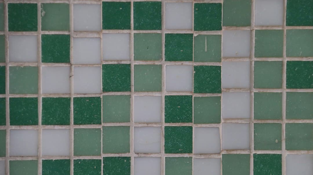 A close up of a green and white tiled wall — Photo by iridial on Unsplash