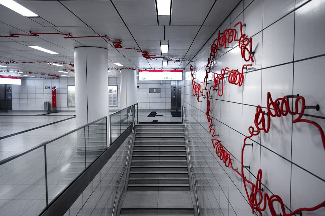 Modern subway station with red art installation — Photo by Julia Taubitz on Unsplash