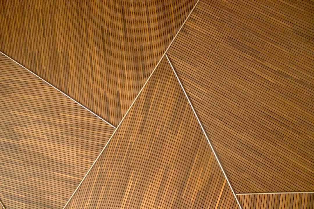 Geometric pattern of thin wooden slats arranged in angled panels — Photo by Teo D on Unsplash
