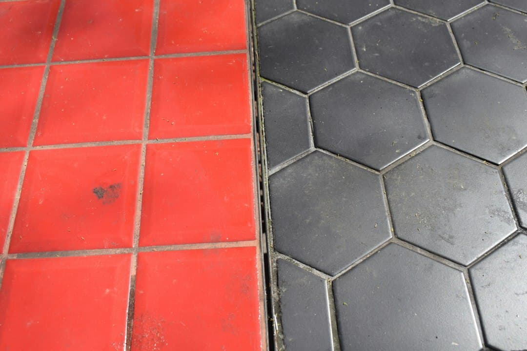 Red square tiles meet black hexagonal tiles — Photo by Marija Zaric on Unsplash