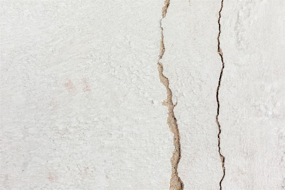 a crack in the side of a white wall — Photo by Natalie Kinnear on Unsplash