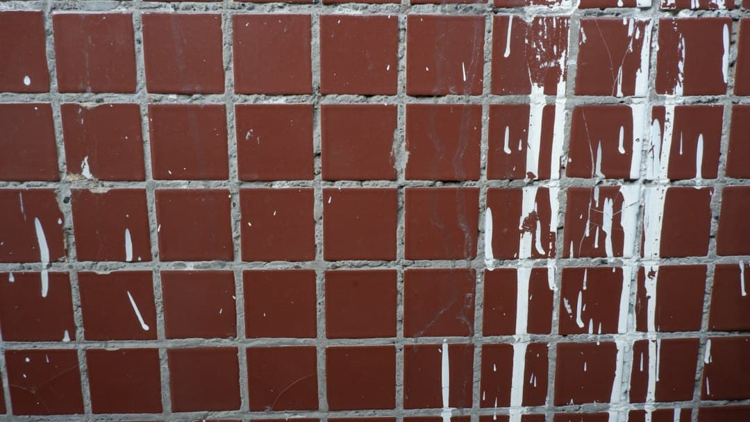 a close up of a brick wall with water running down it — Photo by Vladislav Glukhotko on Unsplash