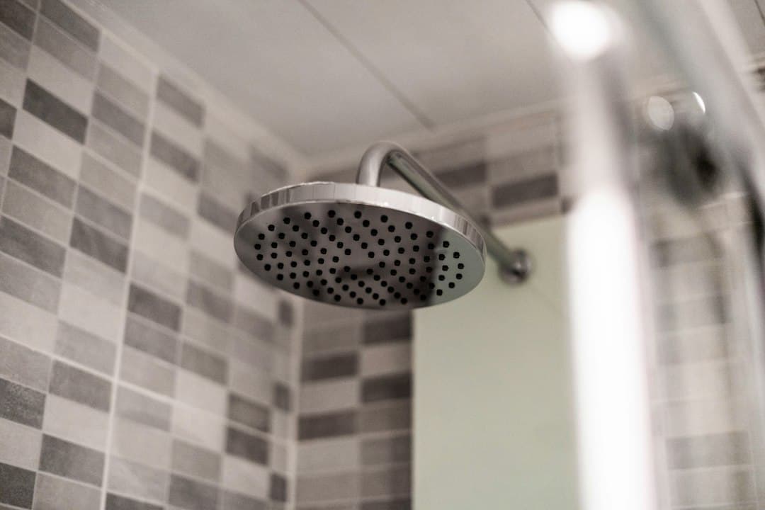 grey stainless steel shower head — Photo by kevin Baquerizo on Unsplash